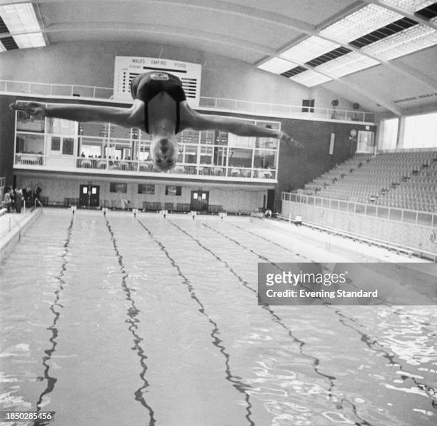 Canadian diver Irene MacDonald in mid-air during a dive at the British Empire and Commonwealth Games, Cardiff, Wales, July 1958.