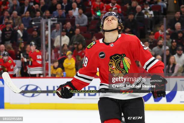 Connor Bedard of the Chicago Blackhawks reacts to a missed shot on goal against the Nashville Predators in overtime at the United Center on December...
