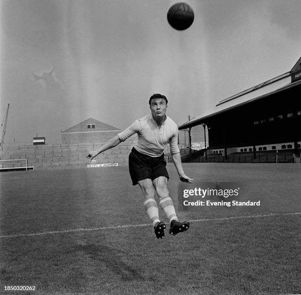 Fulham Football Club defender George Cohen heads a ball during training at Craven Cottage, London, September 15th 1958.