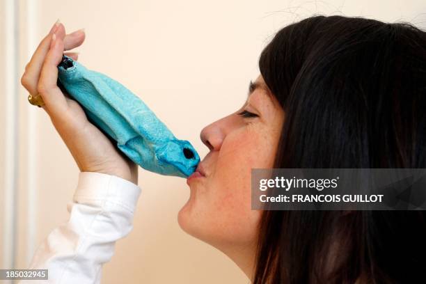 Polish fashion designer Monika Jarosz poses with her products made with Australian cane toads in Paris on October 9, 2013. AFP PHOTO / FRANCOIS...