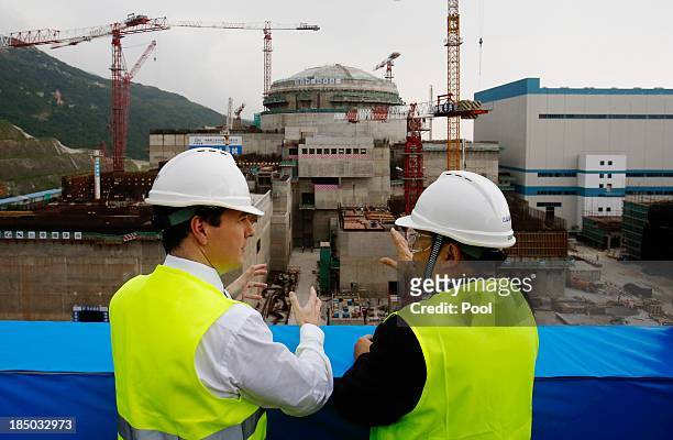 British Chancellor of the Exchequer George Osborne talks with Guo Liming of Taishan Nuclear Power Joint Venture Co Ltd as he tours a nuclear reactor...