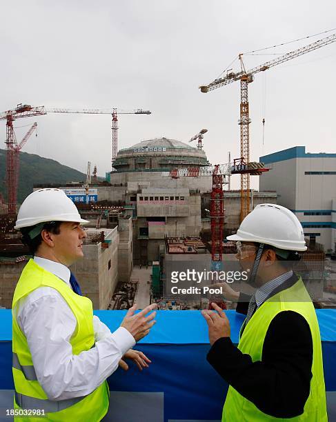 British Chancellor of the Exchequer George Osborne talks with Guo Liming of Taishan Nuclear Power Joint Venture Co Ltd as he tours a nuclear reactor...