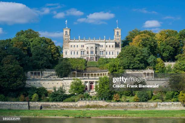 The castle "Albrechtsberg" overlooks the valley Elbe, surrounded by trees..