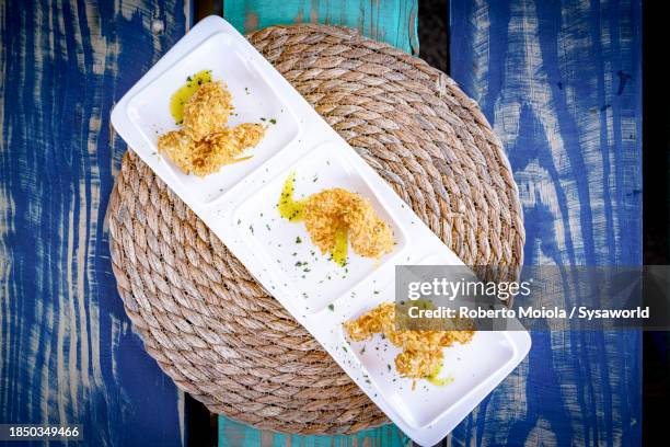 fried coconut shrimp in a tray, overhead view - antígua ilhas leeward imagens e fotografias de stock