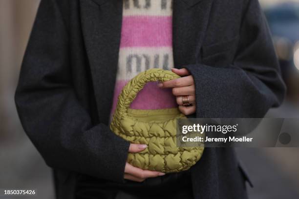 Sonia Lyson seen wearing Miu Miu white / pink striped logo pattern wool knit jumper / sweater, Zara black leather loose pants, COS light khaki green...