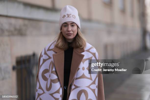 Sonia Lyson seen wearing Louis Vuitton light purple / rose / beige logo pattern oversized wool scarf and wool knit beanie, We are PNTS black loose...