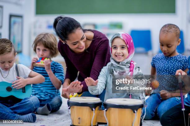 kindergarten music class - playing drums stock pictures, royalty-free photos & images