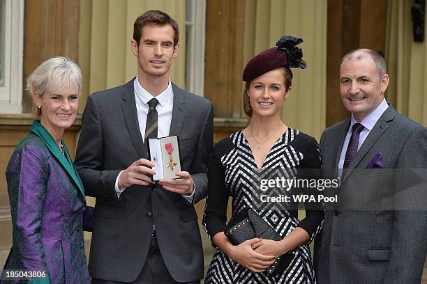 Wimbledon champion Andy Murray, his parents Judy and Will and his girlfriend Kim Sears pose at Buckingham Palace on October 17, 2013 in London,...