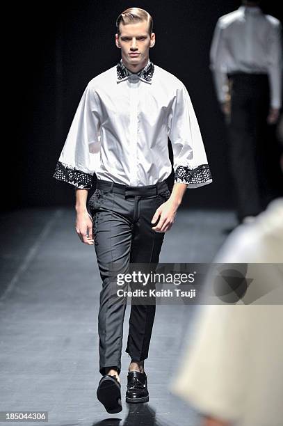 Model showcases designs on the runway during the Christian Dada show as part of Mercedes Benz Fashion Week Tokyo 2014 S/S at Hikarie Hall A of...