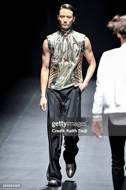 Model showcases designs on the runway during the Christian Dada show as part of Mercedes Benz Fashion Week Tokyo 2014 S/S at Hikarie Hall A of...