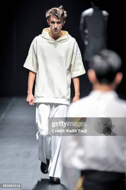 Model showcases designs on the runway during the Christian Dada show as part of Mercedes Benz Fashion Week Tokyo 2014 S/S at Hikarie Hall A of...