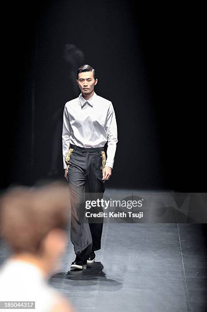 Model showcases designs on the runway during the Christian Dada show as part of Mercedes Benz Fashion Week Tokyo 2014 S/S at Hikarie Hall A of...