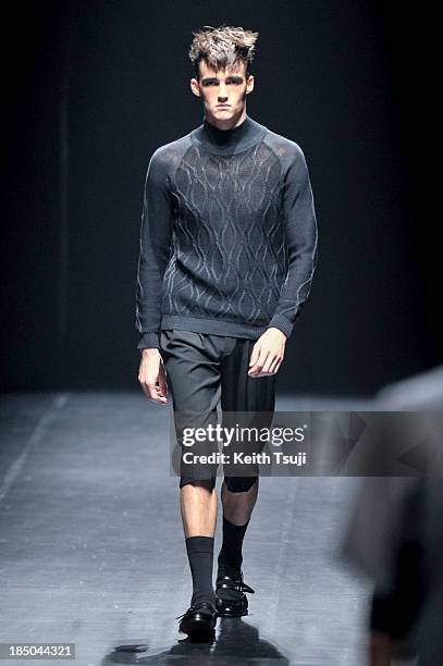 Model showcases designs on the runway during the Christian Dada show as part of Mercedes Benz Fashion Week Tokyo 2014 S/S at Hikarie Hall A of...