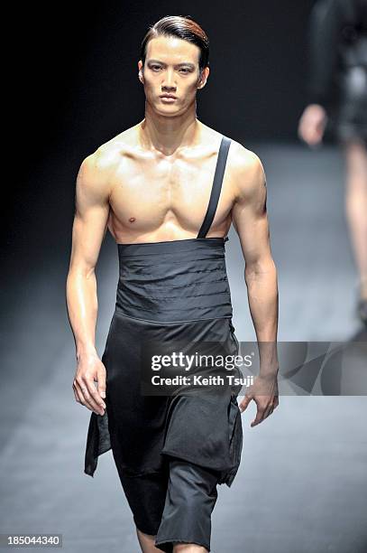 Model showcases designs on the runway during the Christian Dada show as part of Mercedes Benz Fashion Week Tokyo 2014 S/S at Hikarie Hall A of...