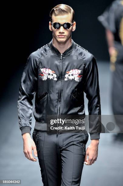 Model showcases designs on the runway during the Christian Dada show as part of Mercedes Benz Fashion Week Tokyo 2014 S/S at Hikarie Hall A of...