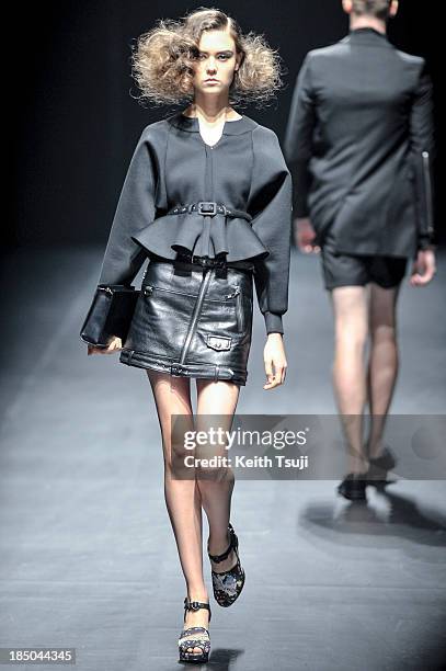 Model showcases designs on the runway during the Christian Dada show as part of Mercedes Benz Fashion Week Tokyo 2014 S/S at Hikarie Hall A of...