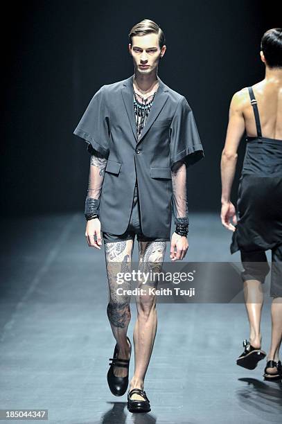 Model showcases designs on the runway during the Christian Dada show as part of Mercedes Benz Fashion Week Tokyo 2014 S/S at Hikarie Hall A of...