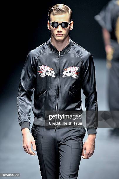 Model showcases designs on the runway during the Christian Dada show as part of Mercedes Benz Fashion Week Tokyo 2014 S/S at Hikarie Hall A of...