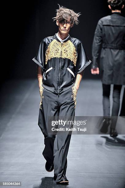 Model showcases designs on the runway during the Christian Dada show as part of Mercedes Benz Fashion Week Tokyo 2014 S/S at Hikarie Hall A of...