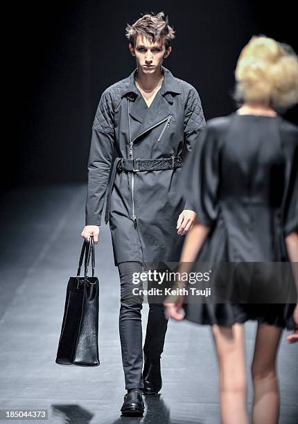 Model showcases designs on the runway during the Christian Dada show as part of Mercedes Benz Fashion Week Tokyo 2014 S/S at Hikarie Hall A of...