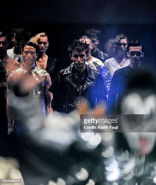 Models showcase designs on the runway along with American rock band KISS during the Christian Dada show as part of Mercedes Benz Fashion Week Tokyo...