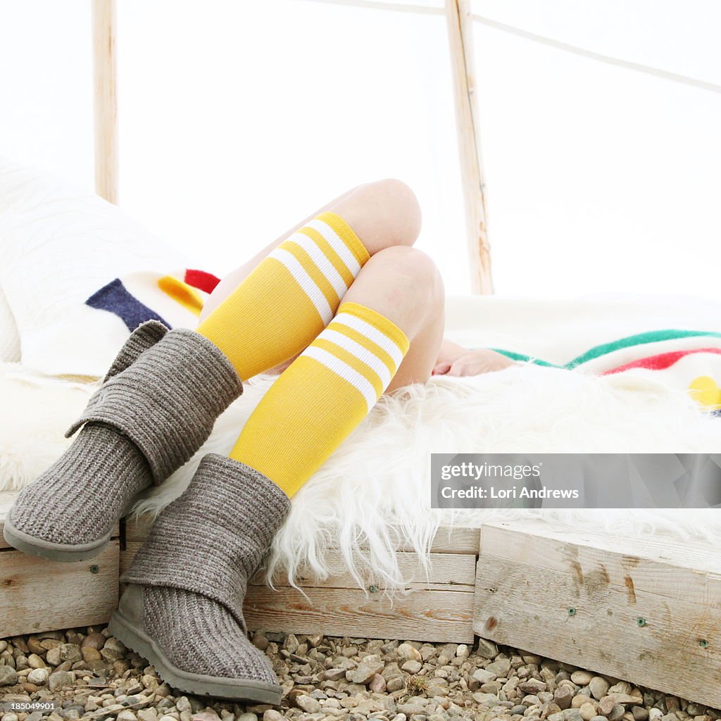 Woman relaxing in a White teepee