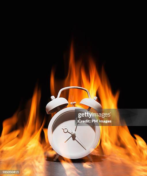 clock on fire - ominous clock stock pictures, royalty-free photos & images