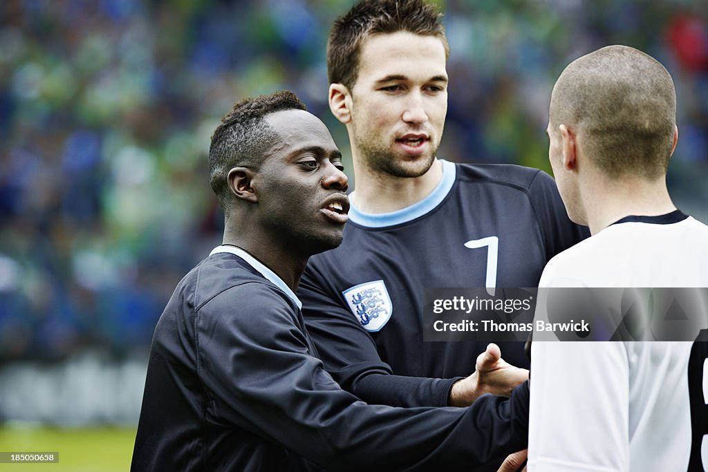 Professional soccer players arguing during match