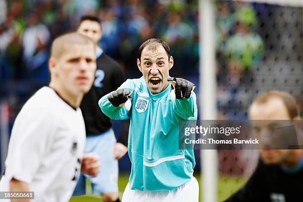 professional soccer goalkeeper directing defense - washington state public stadium authority stock pictures, royalty-free photos & images