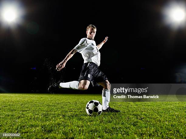soccer player about to kick ball on field - football ストックフォトと画像