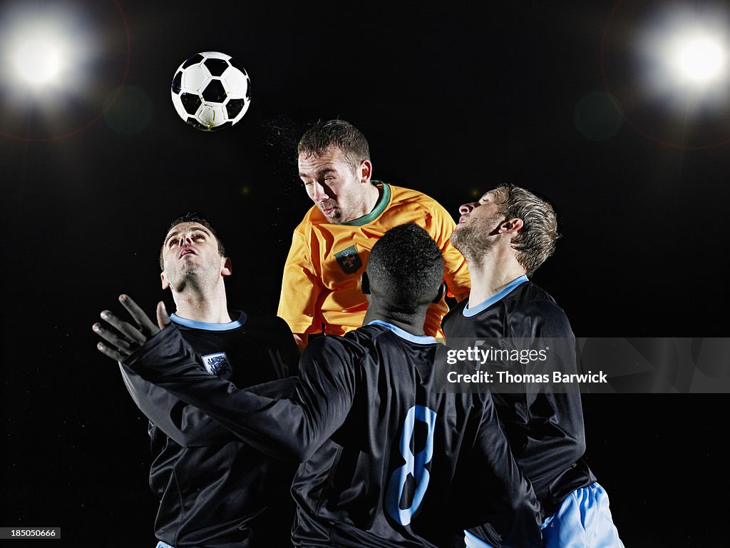 Professional soccer player heading ball