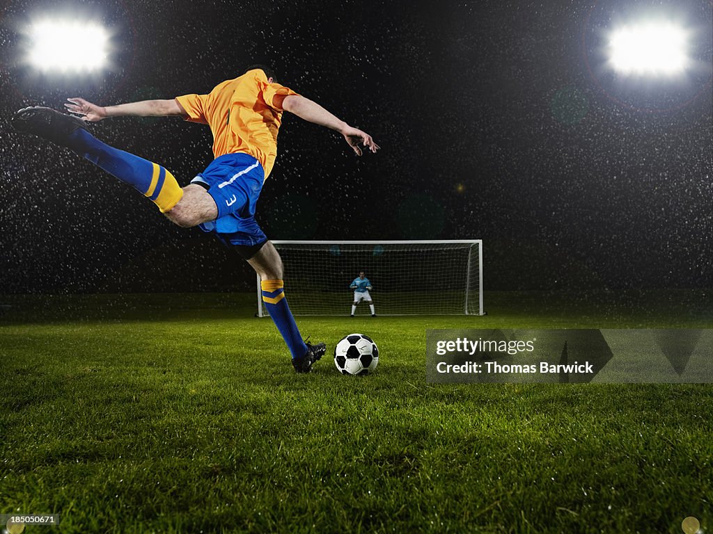 Soccer player about to strike penalty kick