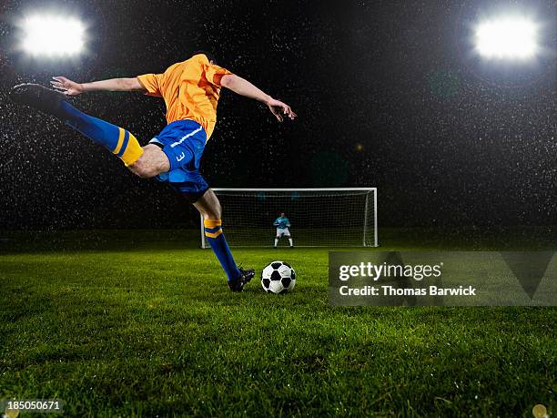 soccer player about to strike penalty kick - goalkeeper soccer stock-fotos und bilder