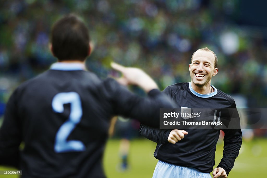 Professional soccer player celebrating in stadium