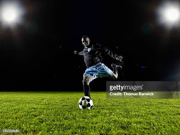 soccer player about to kick ball on field - american football field fotografías e imágenes de stock