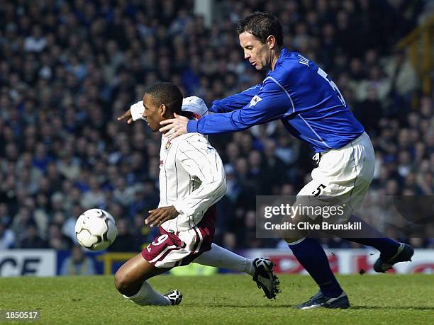 Jermaine Defoe of West Ham is tackled by David Weir of Everton during the FA Barclaycard Premiership match between Everton and West Ham United at...