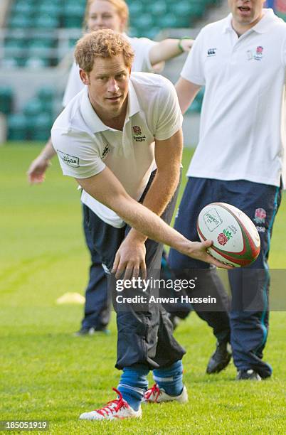 Prince Harry takes part in a rugby training game as he attends RFU All School Programme Coaching Event at Twickenham Stadium on October 17, 2013 in...