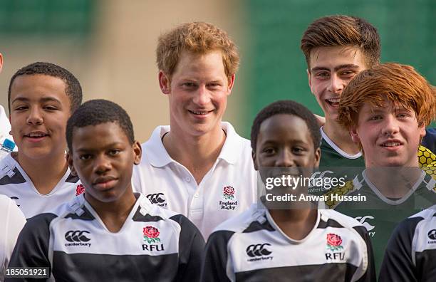 Prince Harry poses with children taking part in the RFU All School Programme Coaching Event at Twickenham Stadium on October 17, 2013 in London,...