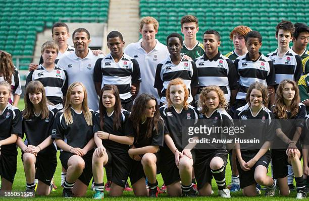 Prince Harry and former England International Jason Robinson pose with children taking part in the RFU All School Programme Coaching Event at...