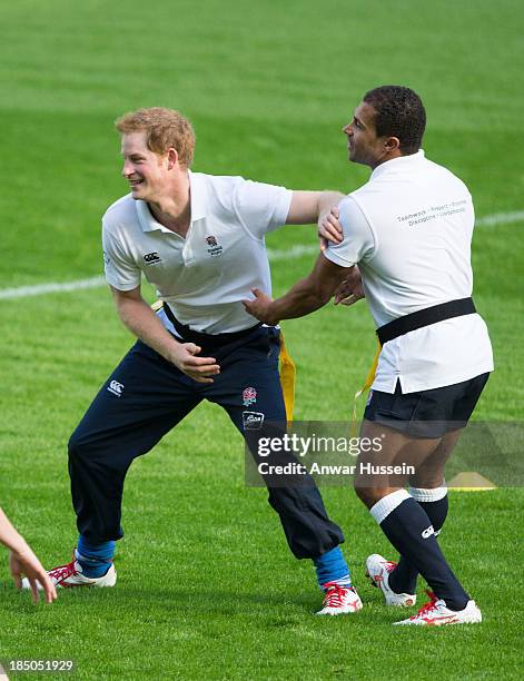 Prince Harry and former England International Jason Robinson take part in a rugby training game as they attend RFU All School Programme Coaching...