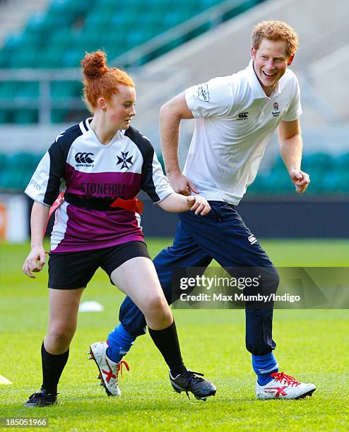 Prince Harry, in his role as Patron of the Rugby Football Union All Schools Programme, takes part in a rugby coaching session at Twickenham Stadium...