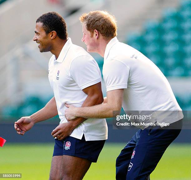 Former England International Jason Robinson and Prince Harry, in his role as Patron of the Rugby Football Union All Schools Programme, tussle as they...