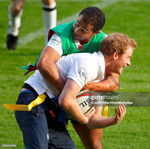 Former England International Jason Robinson and Prince Harry, in his role as Patron of the Rugby Football Union All Schools Programme, tussle as they...
