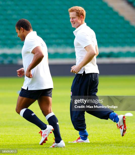 Former England International Jason Robinson and Prince Harry, in his role as Patron of the Rugby Football Union All Schools Programme, take part in a...