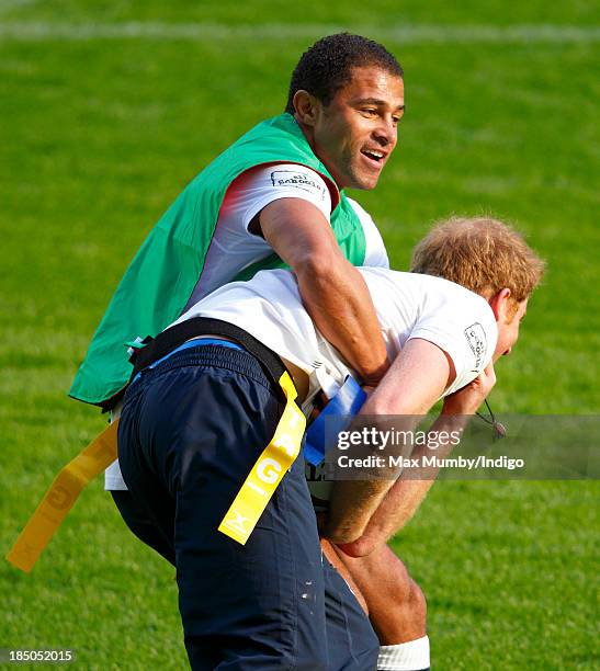 Former England International Jason Robinson and Prince Harry, in his role as Patron of the Rugby Football Union All Schools Programme, tussle as they...