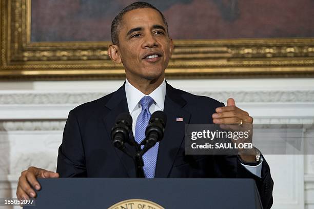 President Barack Obama speaks about the reopening of government following a shutdown in the State Dining Room of the White House in Washington, DC,...