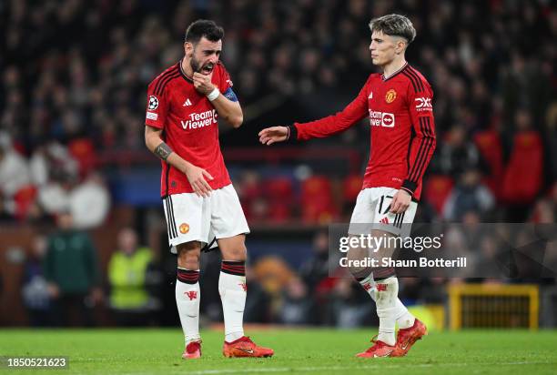 Bruno Fernandes of Manchester United reacts after a collision with Dayot Upamecano of Bayern Munich during the UEFA Champions League match between...