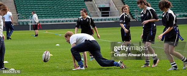 Prince Harry takes part in a rugby training game as he attends RFU All School Programme Coaching Event at Twickenham Stadium on October 17, 2013 in...