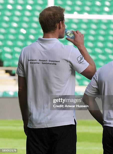 Prince Harry drinks water as he takes part in a rugby training game as he attends RFU All School Programme Coaching Event at Twickenham Stadium on...