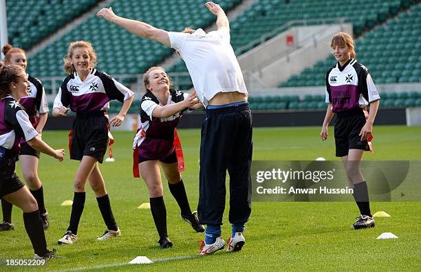 Prince Harry takes part in a rugby training game with girls as he attends RFU All School Programme Coaching Event at Twickenham Stadium on October...